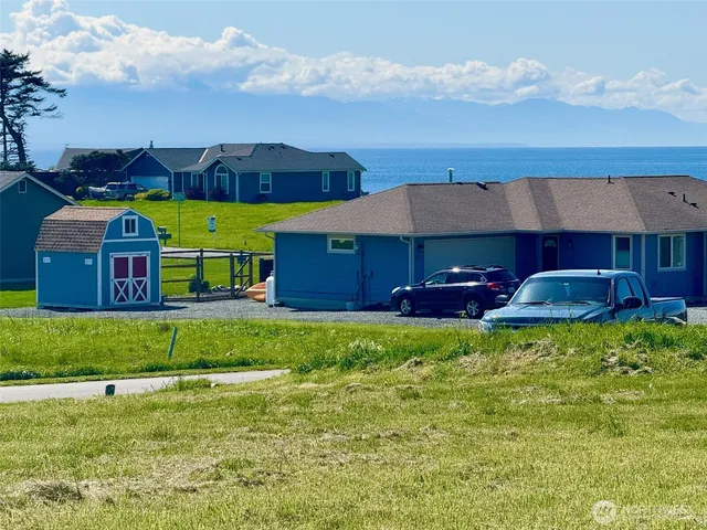 a view of a house with a yard and sitting area