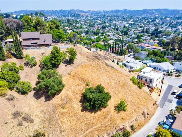 an aerial view of a house with a yard and trees