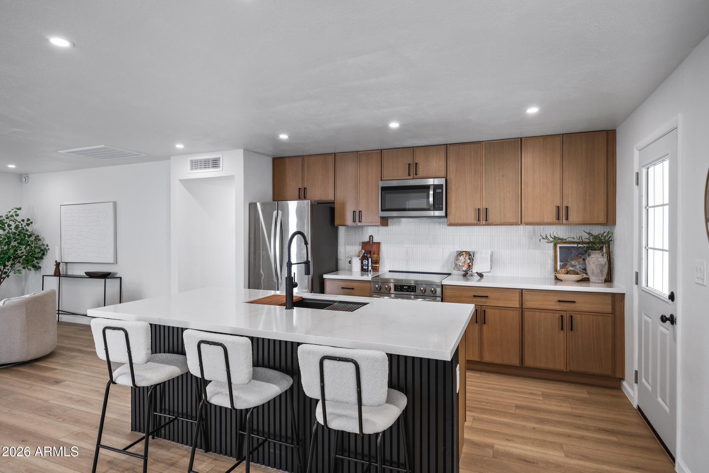 1237 East Ruth Avenue Phoenix, AZ 85020 - Photo 11 of 38 a kitchen with kitchen island a dining table chairs stainless steel appliances and cabinets