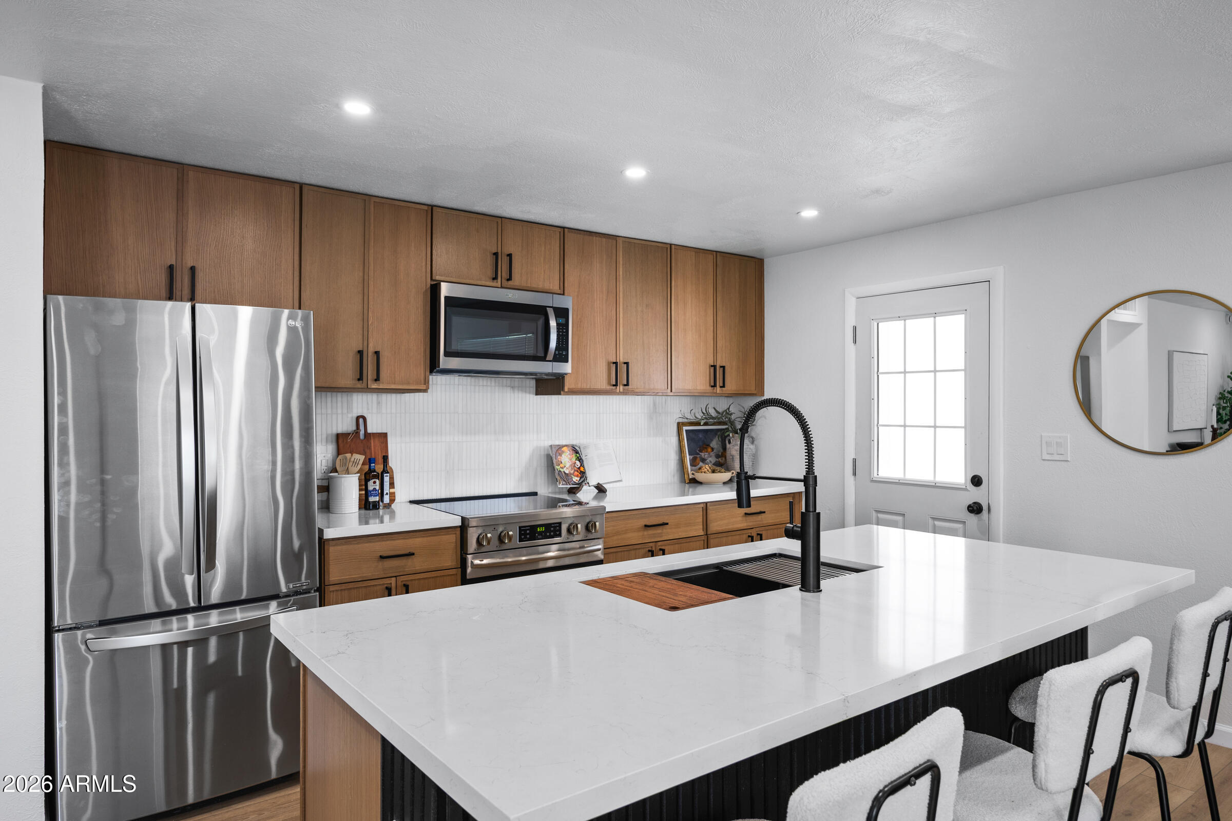 1237 East Ruth Avenue Phoenix, AZ 85020 - Photo 12 of 38 a kitchen with kitchen island a sink refrigerator and a stove with wooden floor
