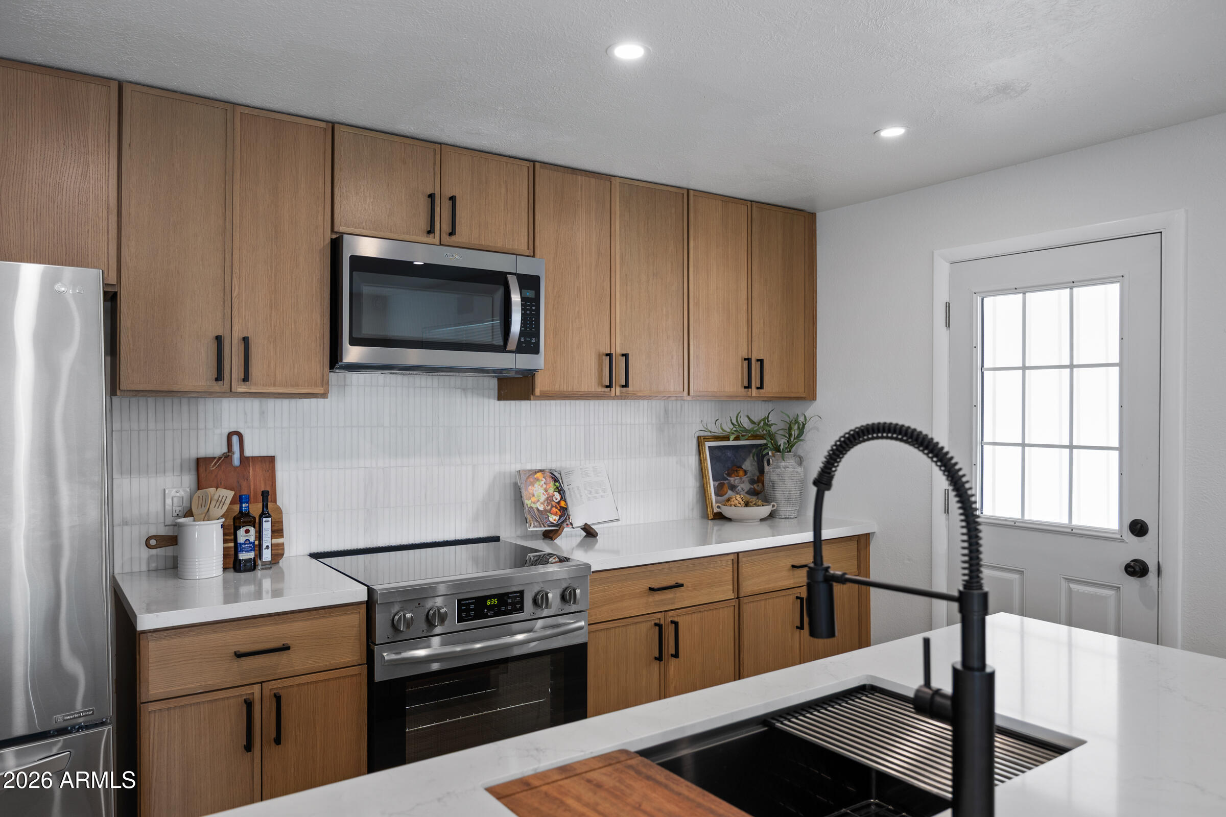 1237 East Ruth Avenue Phoenix, AZ 85020 - Photo 13 of 38 a kitchen with a sink a stove and cabinets
