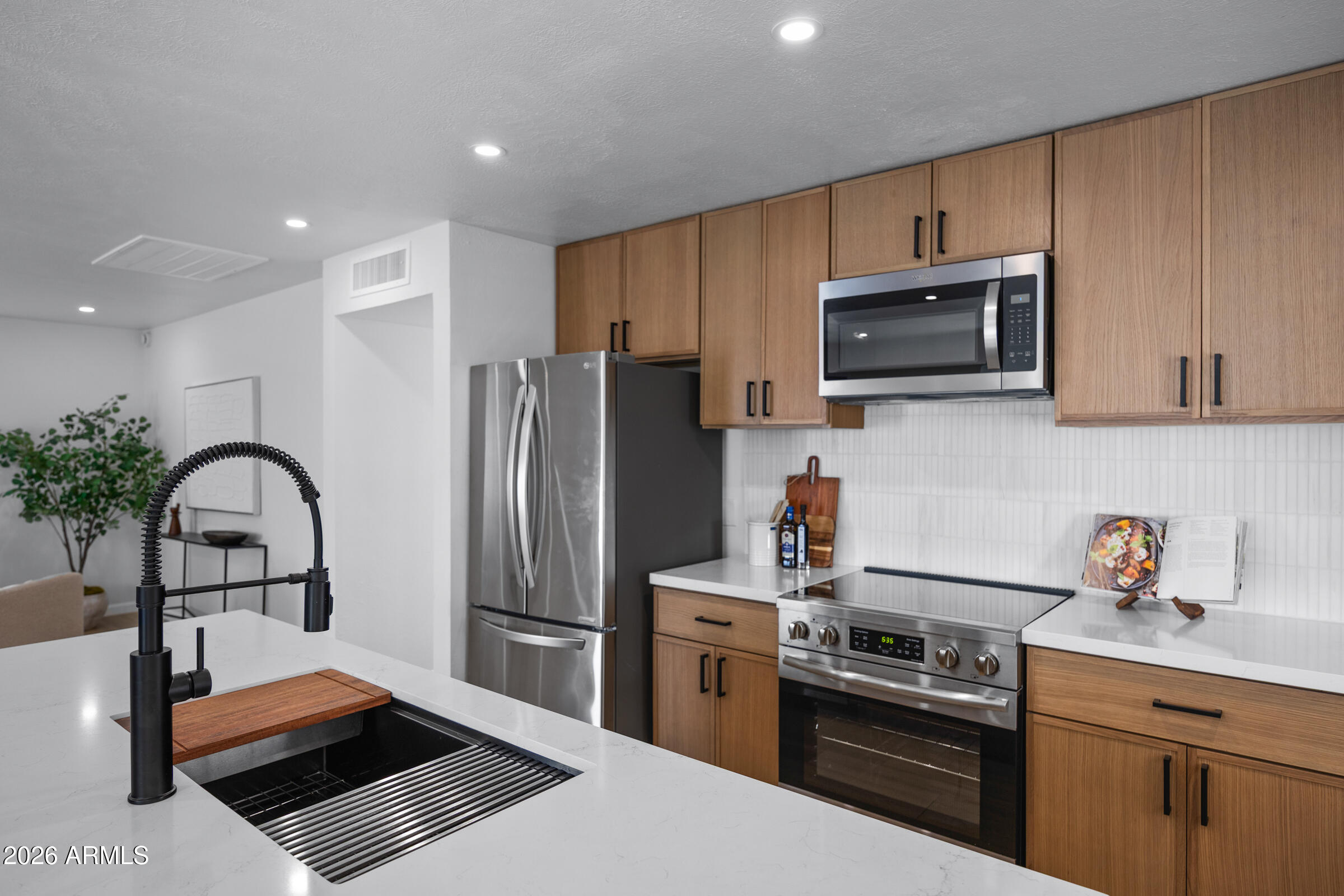 1237 East Ruth Avenue Phoenix, AZ 85020 - Photo 14 of 38 a kitchen with stainless steel appliances a stove microwave sink refrigerator and cabinets