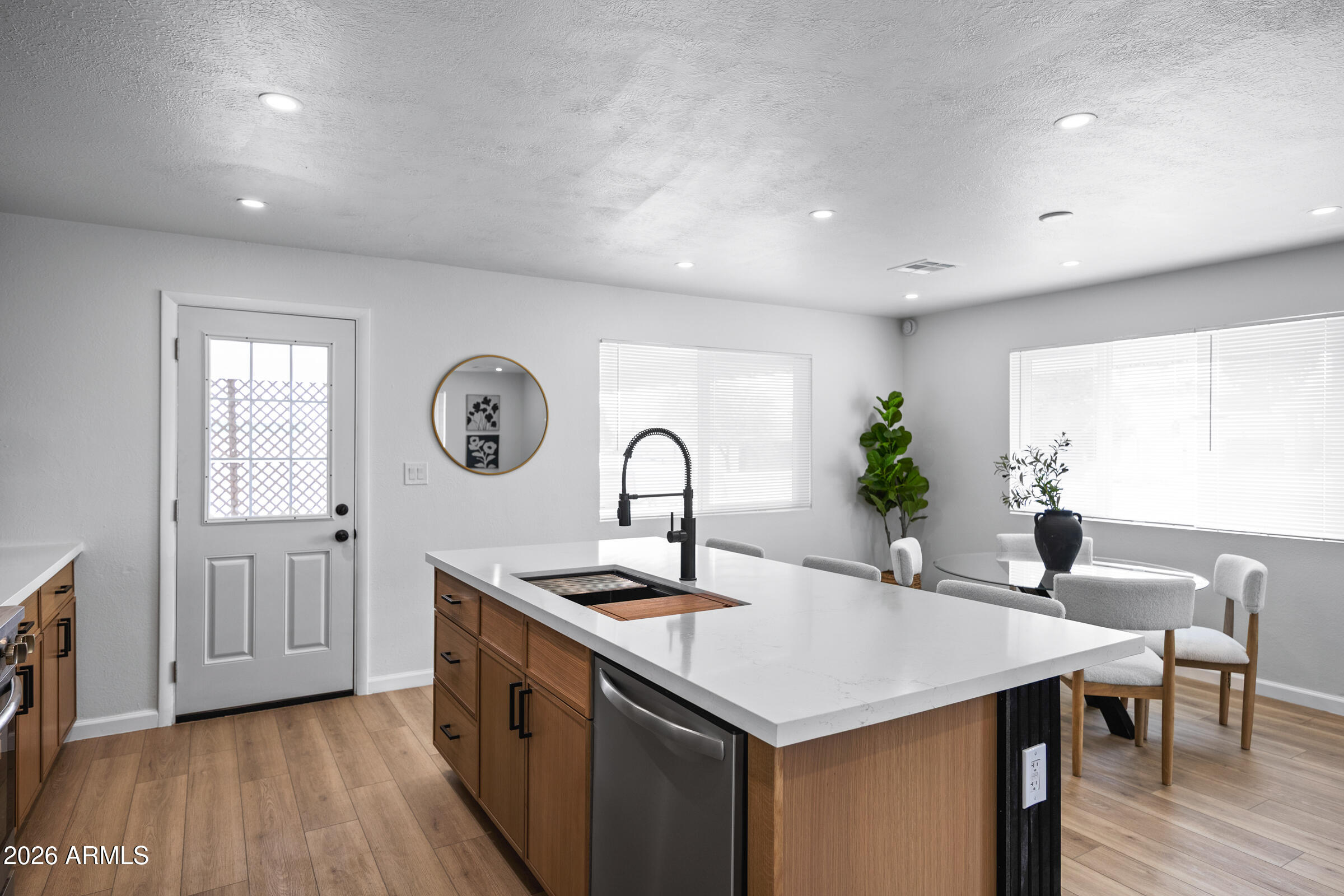 1237 East Ruth Avenue Phoenix, AZ 85020 - Photo 16 of 38 a kitchen with kitchen island a sink and a stove top oven