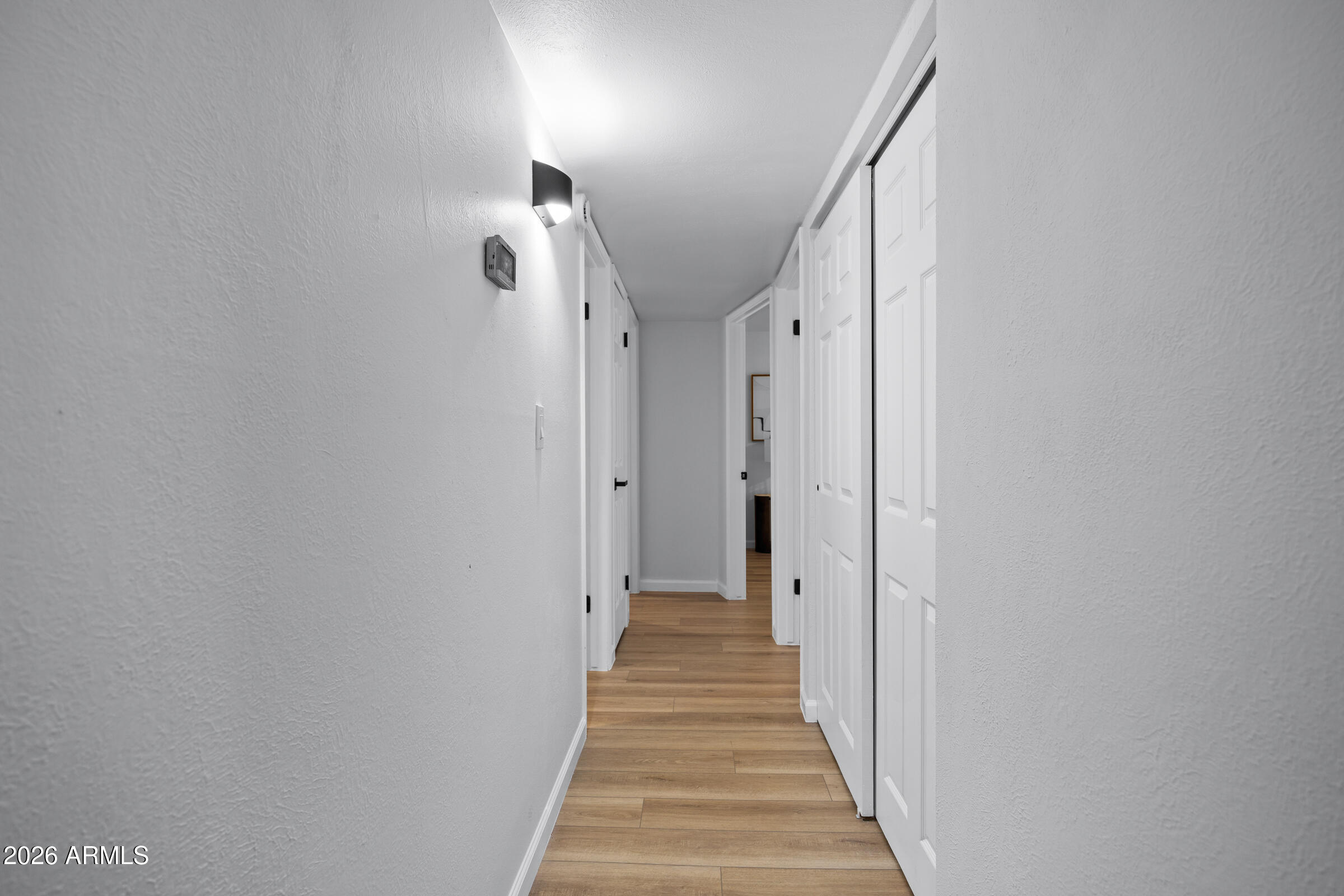 1237 East Ruth Avenue Phoenix, AZ 85020 - Photo 19 of 38 a view of a hallway with wooden floor and entryway