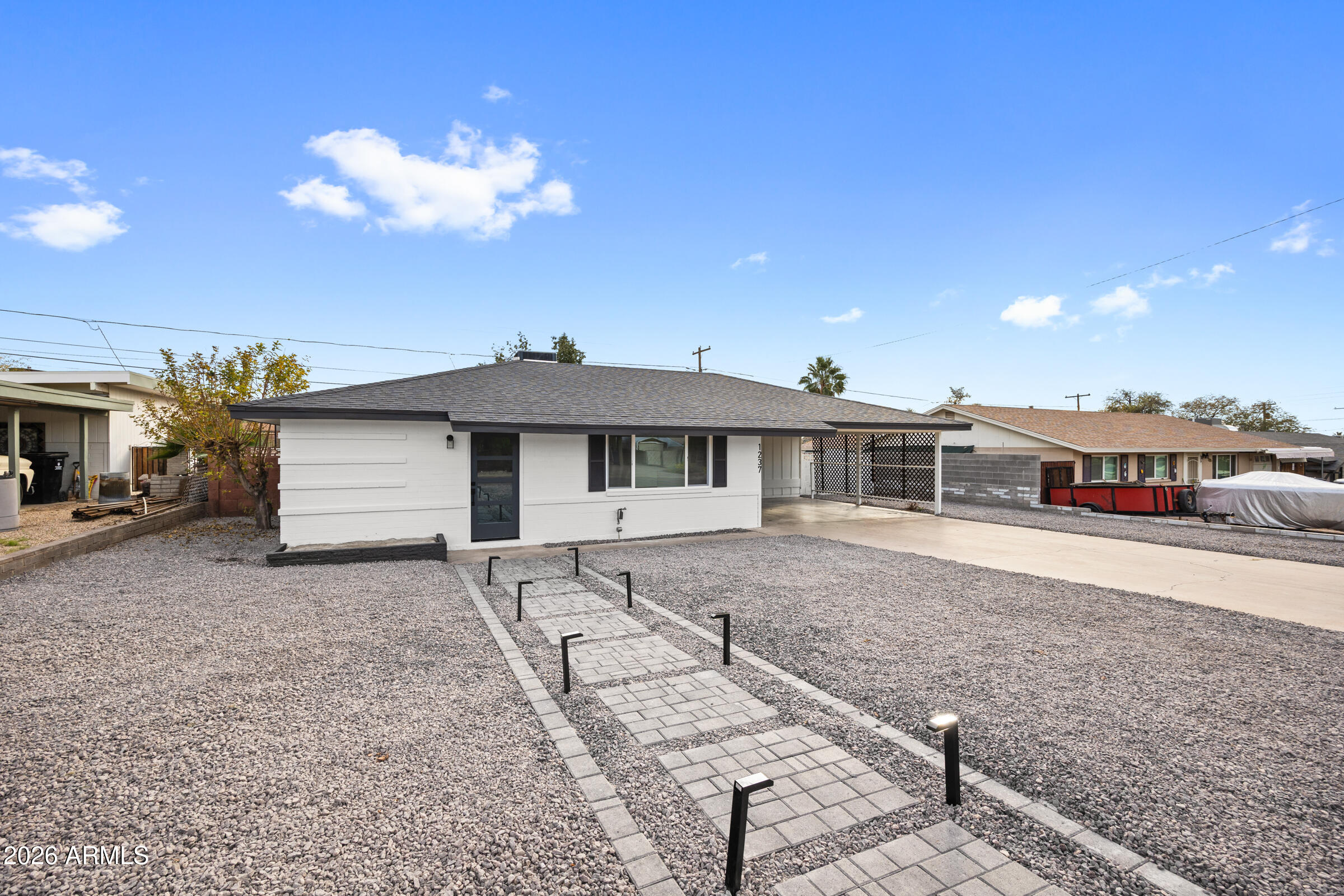 1237 East Ruth Avenue Phoenix, AZ 85020 - Photo 2 of 38 a front view of a house with a yard and garage