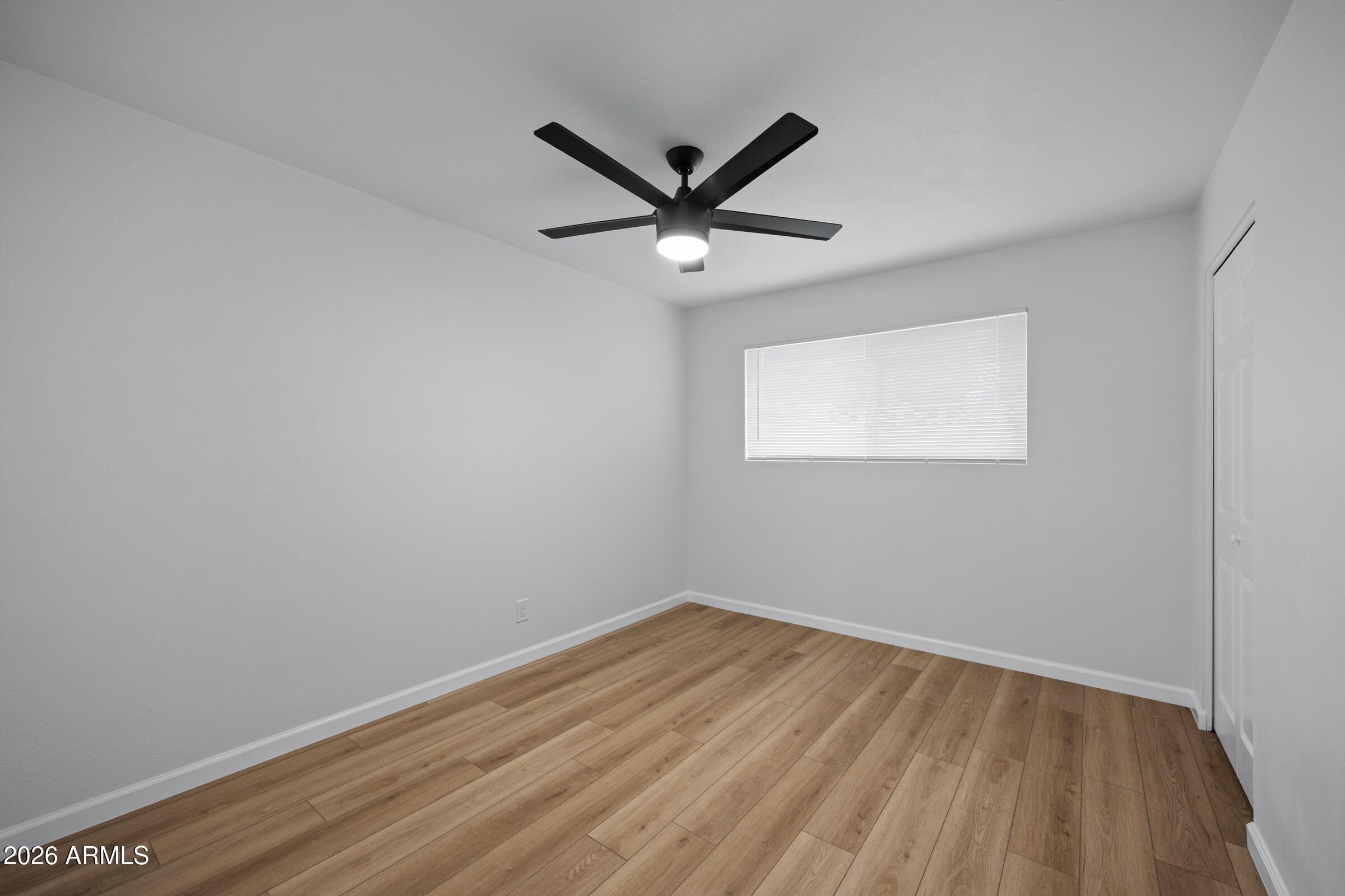 1237 East Ruth Avenue Phoenix, AZ 85020 - Photo 21 of 38 a view of a big room with wooden floor and windows