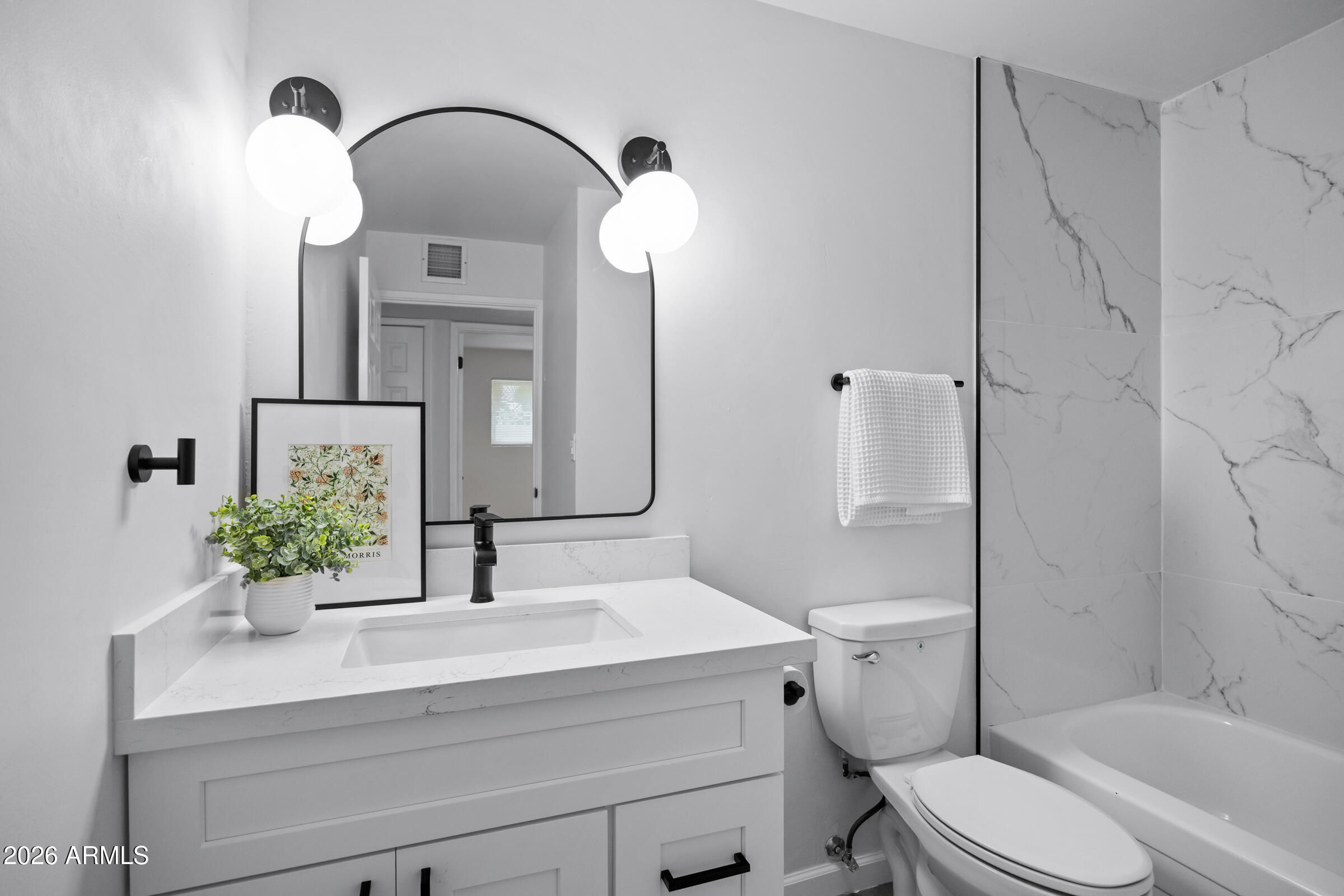 1237 East Ruth Avenue Phoenix, AZ 85020 - Photo 22 of 38 a bathroom with a sink vanity mirror and toilet