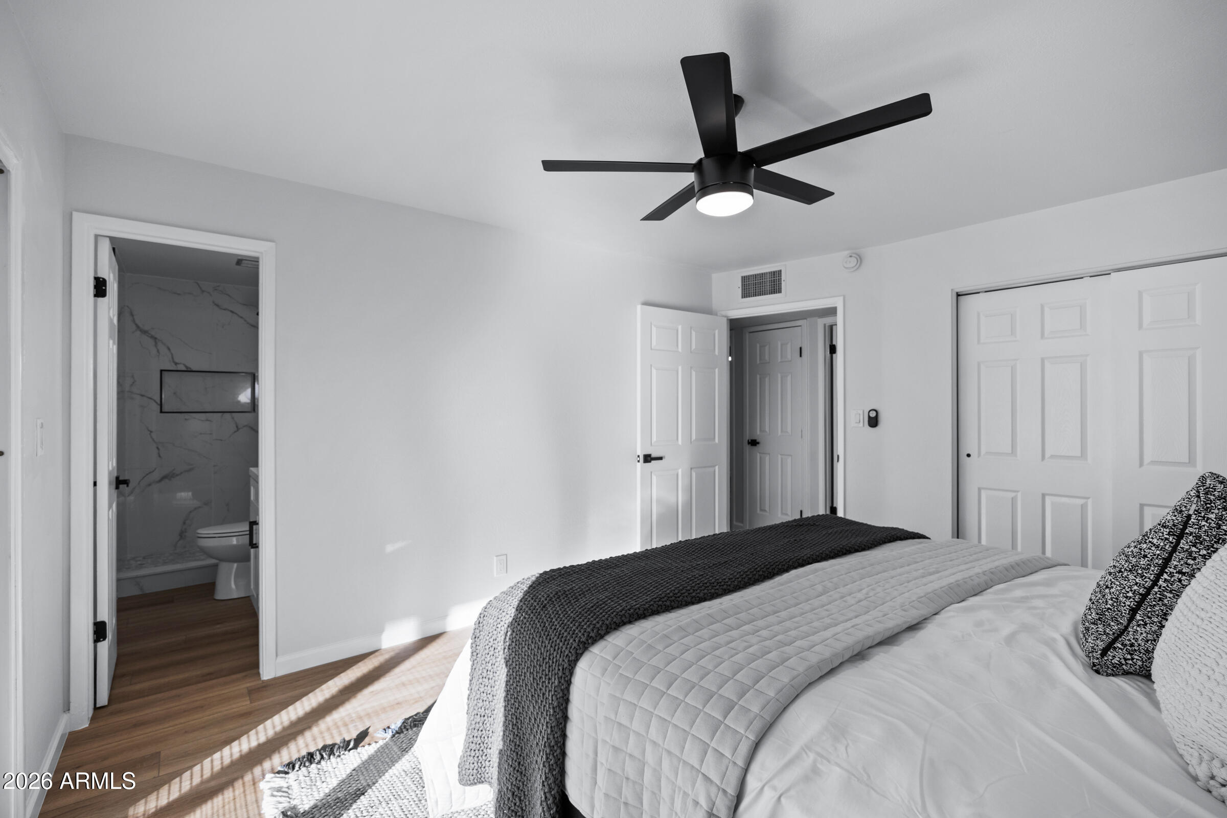 1237 East Ruth Avenue Phoenix, AZ 85020 - Photo 27 of 38 a bedroom with a large bed and a chandelier