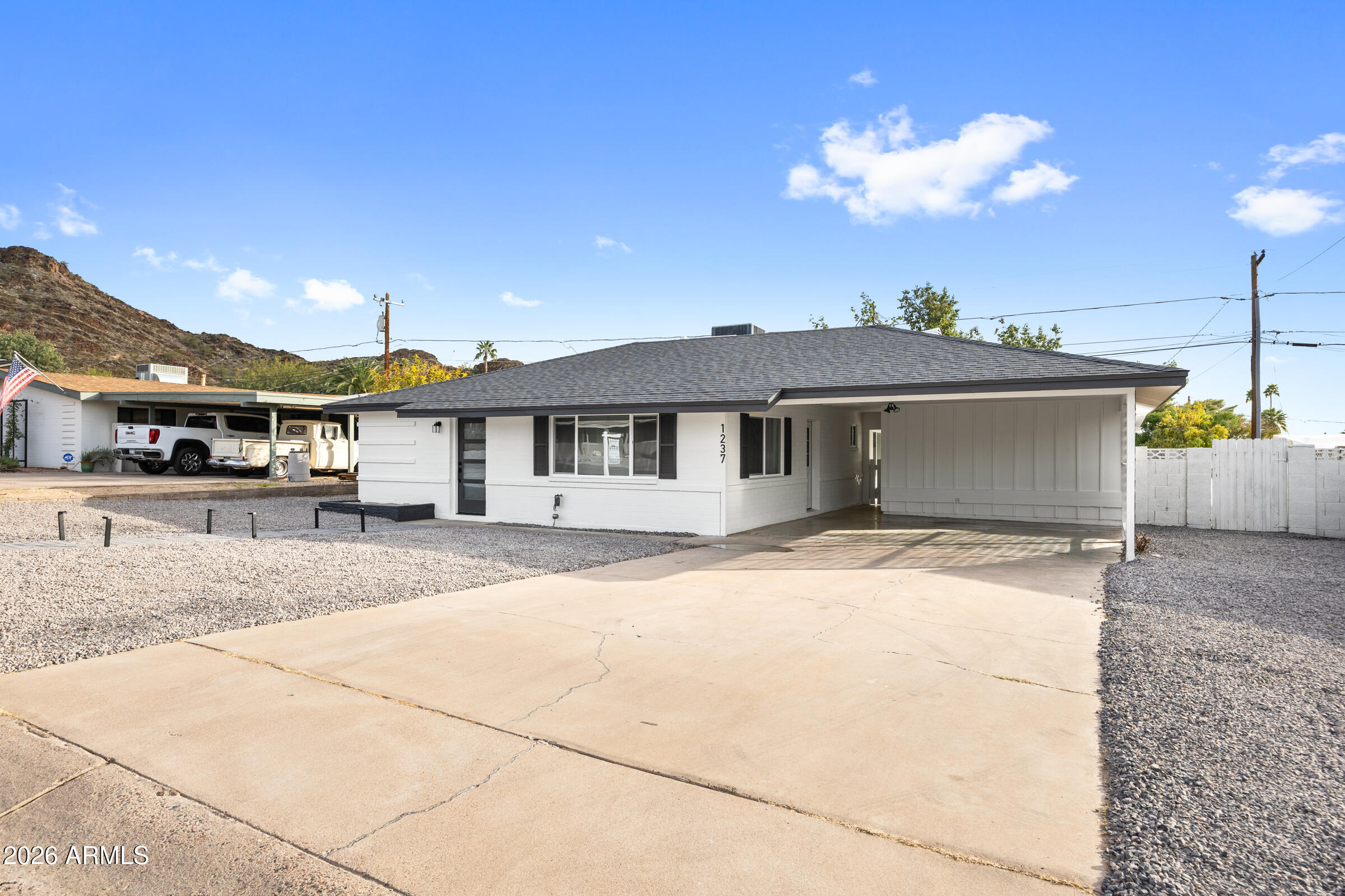 1237 East Ruth Avenue Phoenix, AZ 85020 - Photo 3 of 38 a front view of a house with a yard and garage
