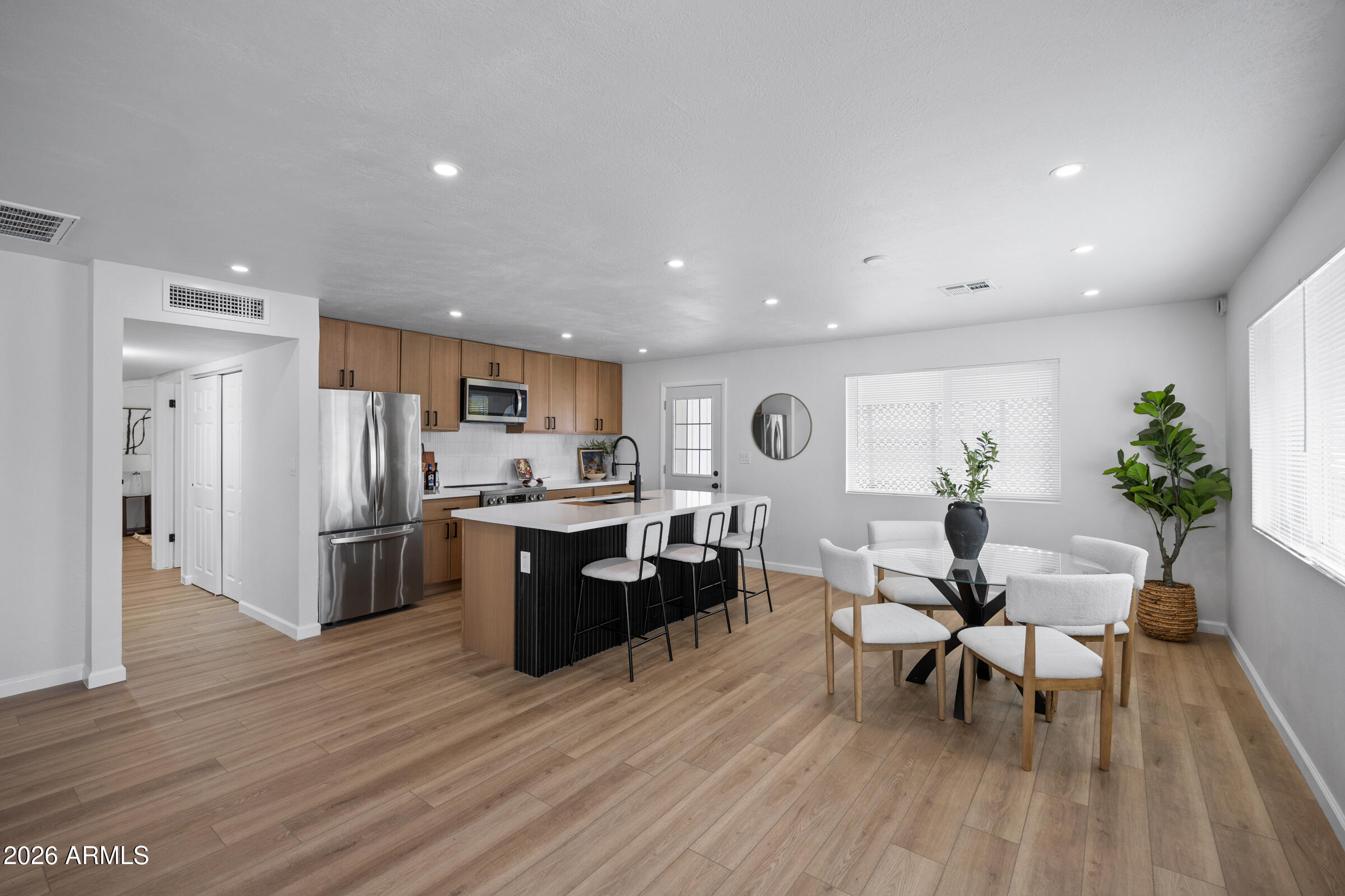 1237 East Ruth Avenue Phoenix, AZ 85020 - Photo 5 of 38 a living room with stainless steel appliances furniture wooden floor and a kitchen view