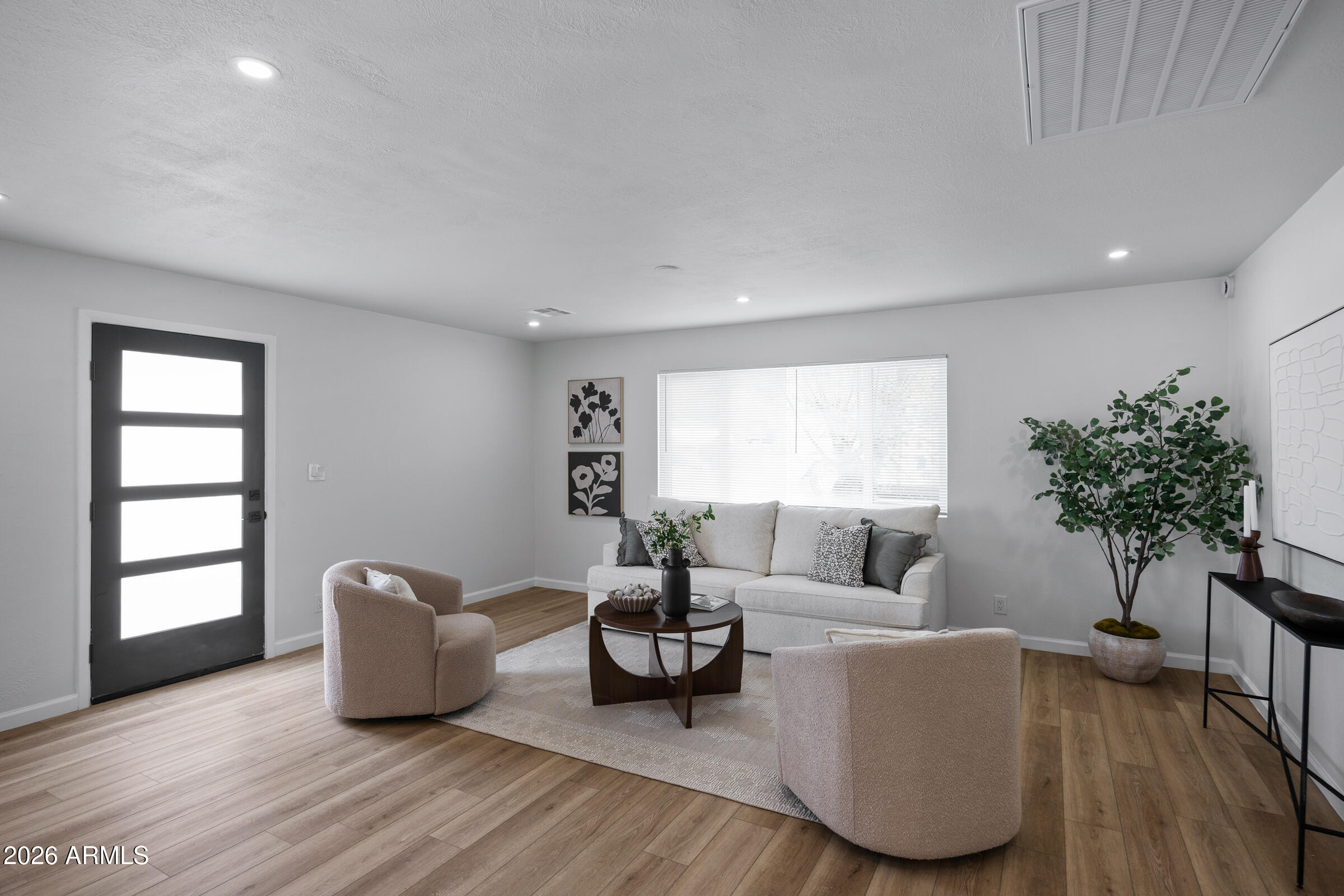 1237 East Ruth Avenue Phoenix, AZ 85020 - Photo 6 of 38 a living room with furniture and a potted plant