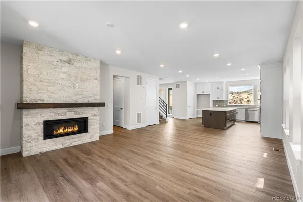 a view of a kitchen with a sink a fireplace and a window