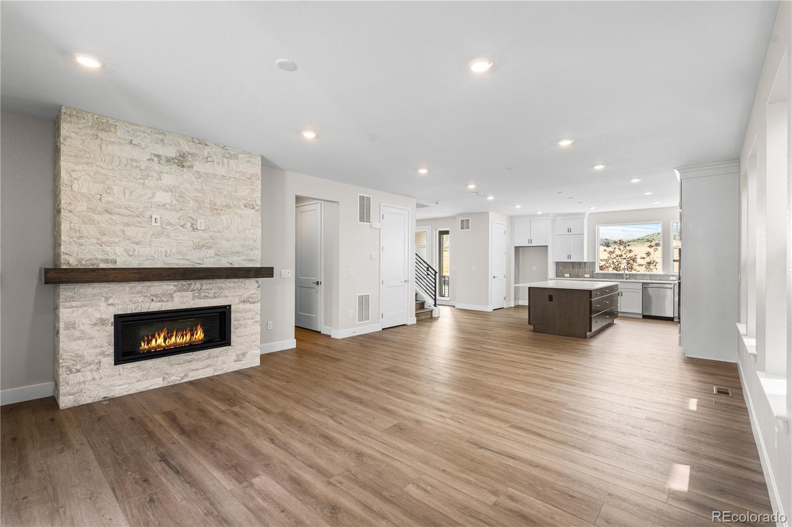 11208 Vibrato Lane Lone Tree, CO 80134 - Photo 12 of 40 a view of a kitchen with a sink a fireplace and a window
