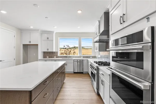 a kitchen with stainless steel appliances a stove cabinets and microwave
