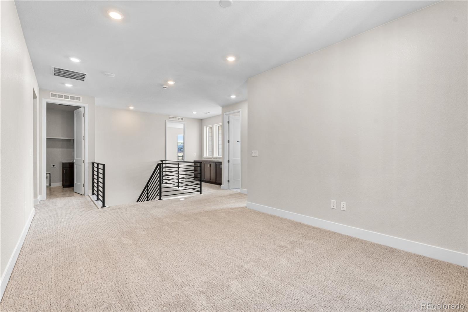 11208 Vibrato Lane Lone Tree, CO 80134 - Photo 20 of 40 a view of an empty room with wooden floor