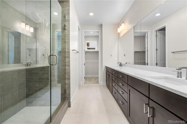 a bathroom with a double vanity sink and mirror