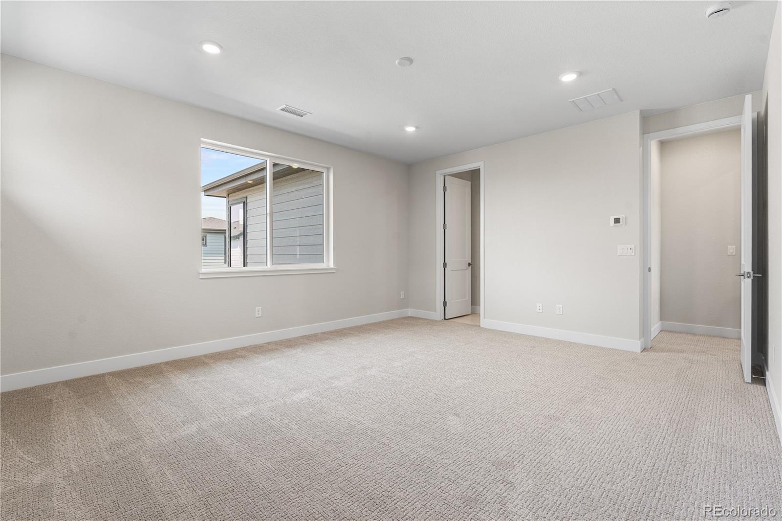 11208 Vibrato Lane Lone Tree, CO 80134 - Photo 29 of 40 a view of an empty room with a window