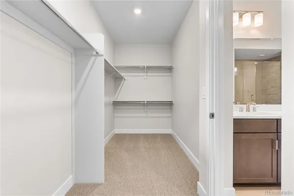 a view of walk in closet with empty racks