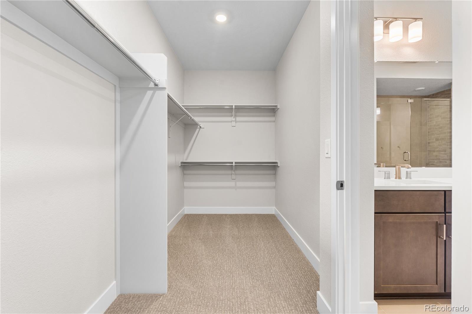 11208 Vibrato Lane Lone Tree, CO 80134 - Photo 30 of 40 a view of walk in closet with empty racks