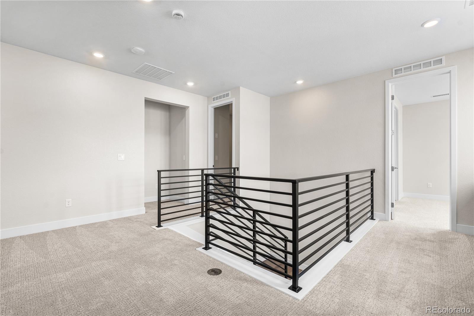 11208 Vibrato Lane Lone Tree, CO 80134 - Photo 32 of 40 a view of a hallway with stairs