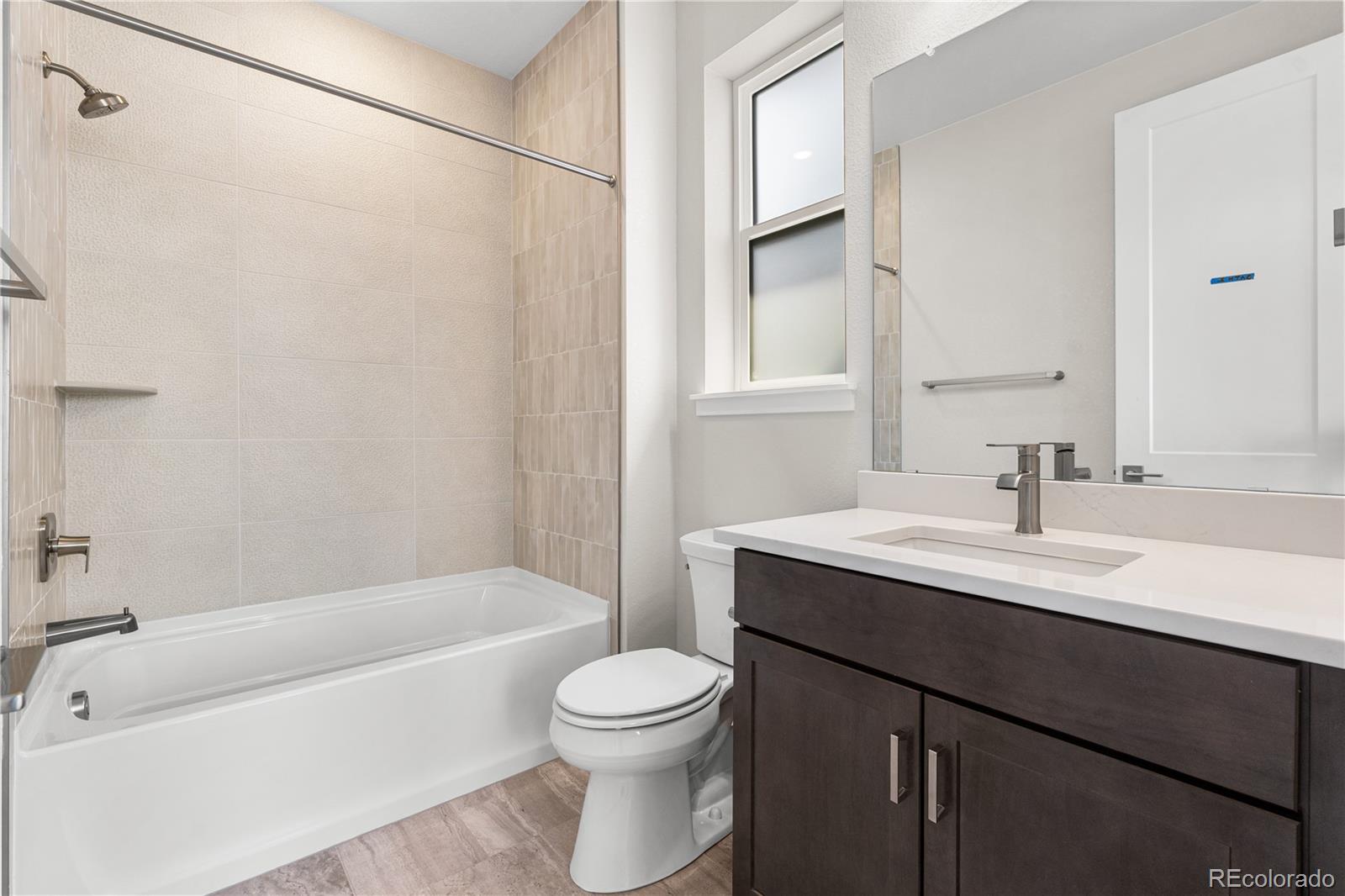 11208 Vibrato Lane Lone Tree, CO 80134 - Photo 34 of 40 a bathroom with a sink a toilet and a bathtub
