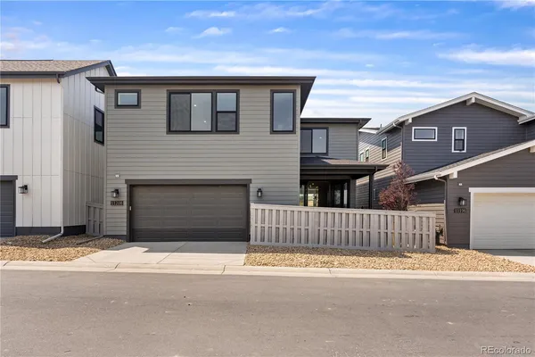 a front view of a house with a fence