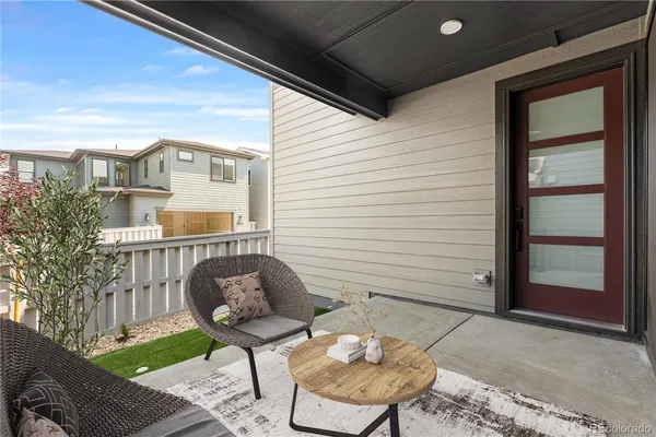 a backyard of a house with barbeque oven table and chairs