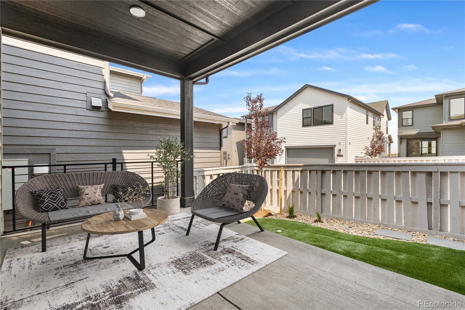 11208 Vibrato Lane Lone Tree, CO 80134 - Photo 40 of 40 a backyard of a house with barbeque oven table and chairs