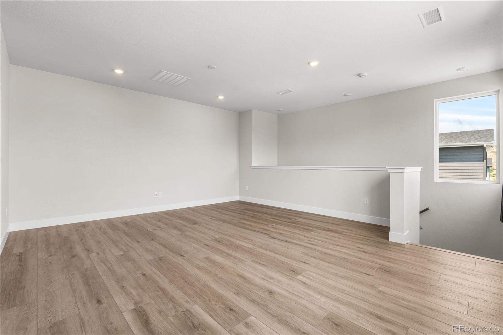 11208 Vibrato Lane Lone Tree, CO 80134 - Photo 10 of 40 a view of empty room with wooden floor
