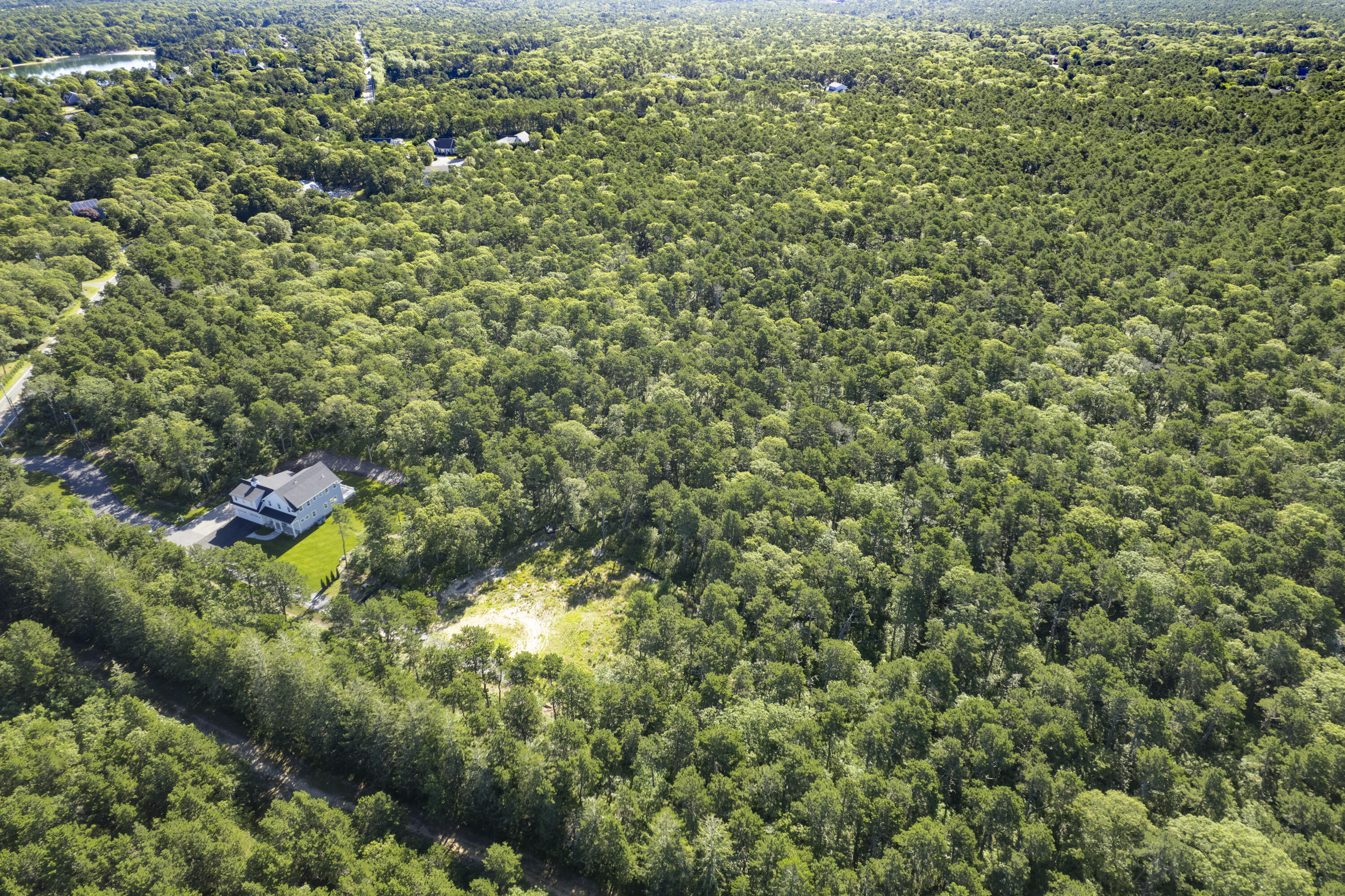 0 South Orleans Road Harwich, MA 02645 - Photo 3 of 3 a view of a house with a lush green forest