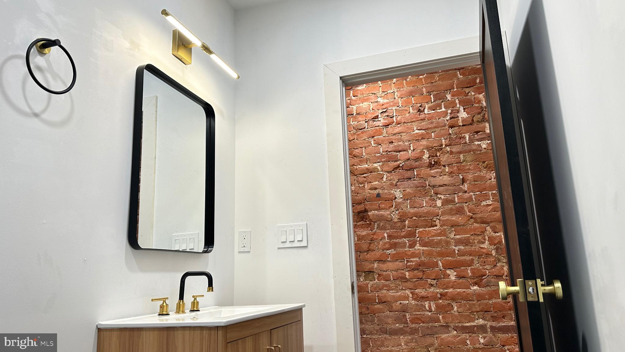 3924 North 13th Street, Unit A Philadelphia, PA 19140 - Photo 11 of 18 a bathroom with a sink and a mirror