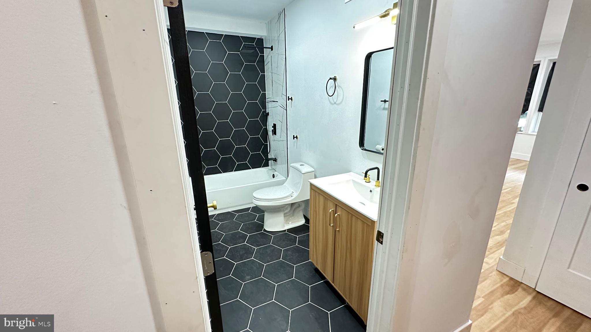 3924 North 13th Street, Unit A Philadelphia, PA 19140 - Photo 7 of 18 a bathroom with a toilet and a shower