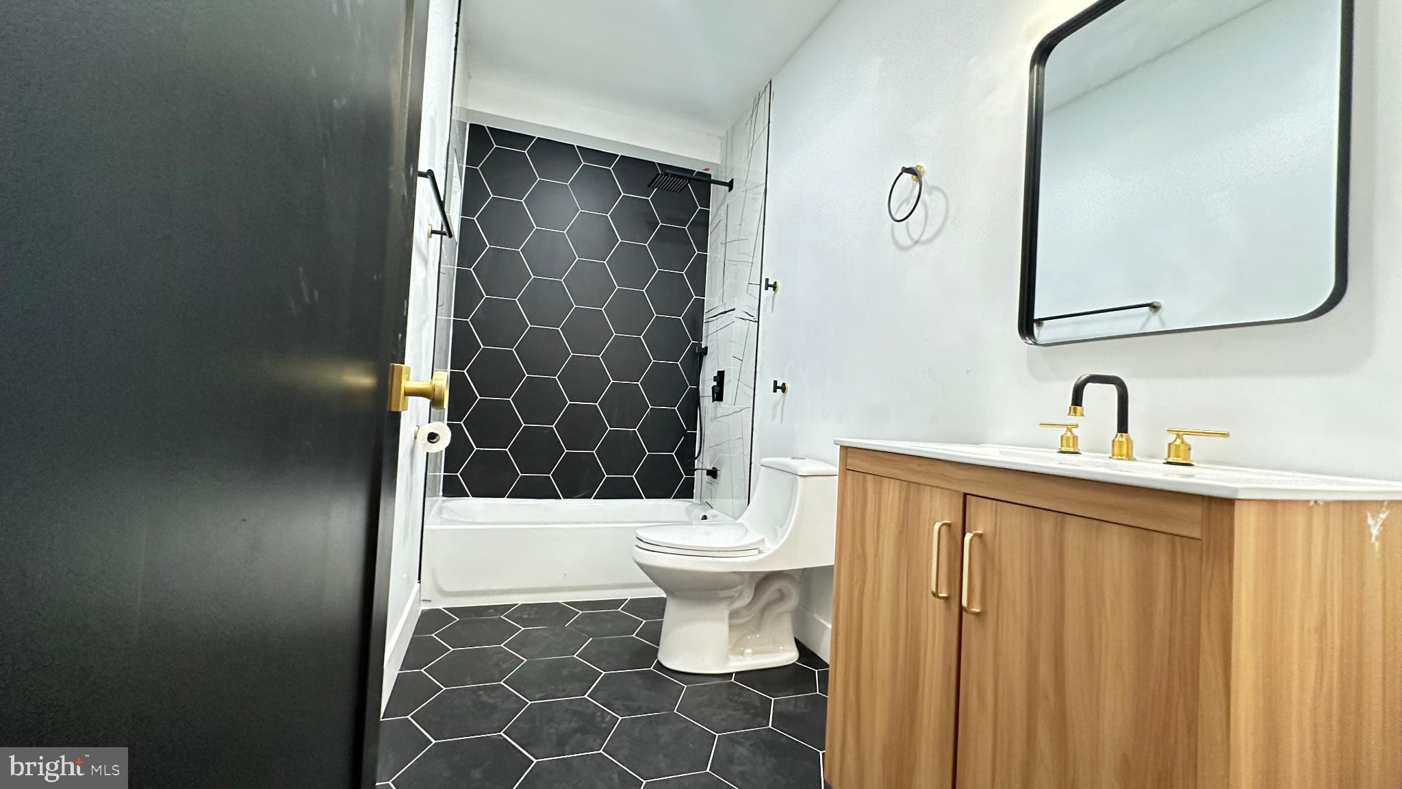 3924 North 13th Street, Unit A Philadelphia, PA 19140 - Photo 8 of 18 a bathroom with a sink a toilet and shower