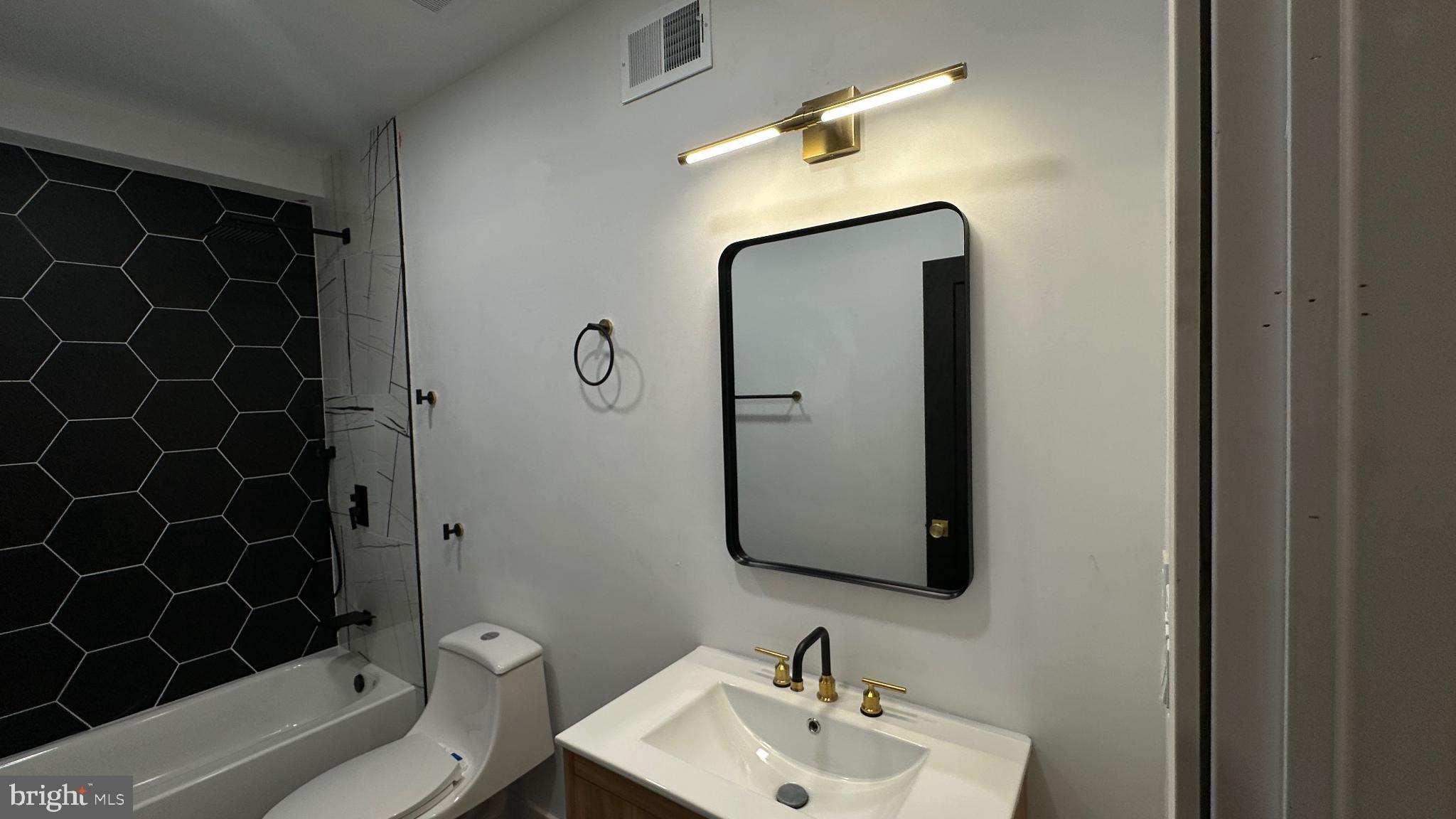 3924 North 13th Street, Unit A Philadelphia, PA 19140 - Photo 9 of 18 a bathroom with a sink toilet and shower