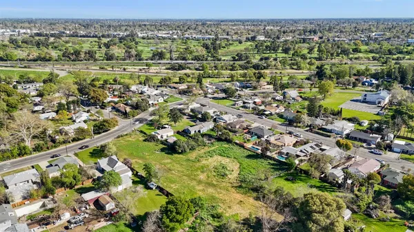 an aerial view of residential houses with outdoor space