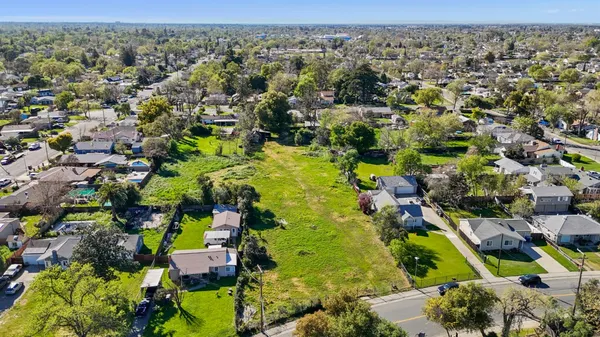 an aerial view of residential houses with yard
