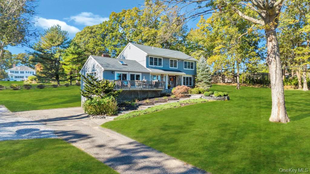 39 Bevin Road Northport, NY 11768 - Photo 3 of 44 View of front of house with a front yard, driveway, and view of wooded area
