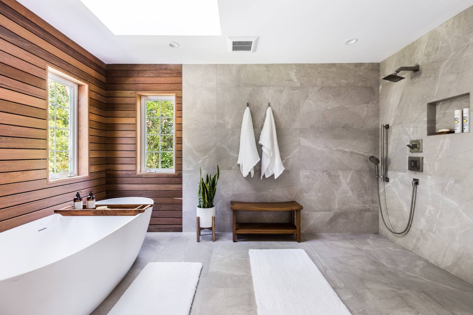 a bathroom with a tub sink and mirror