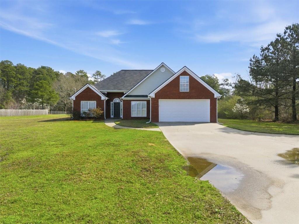 493 Youth Jersey Road Covington, GA 30014 - Photo 5 of 52 a front view of a house with a yard