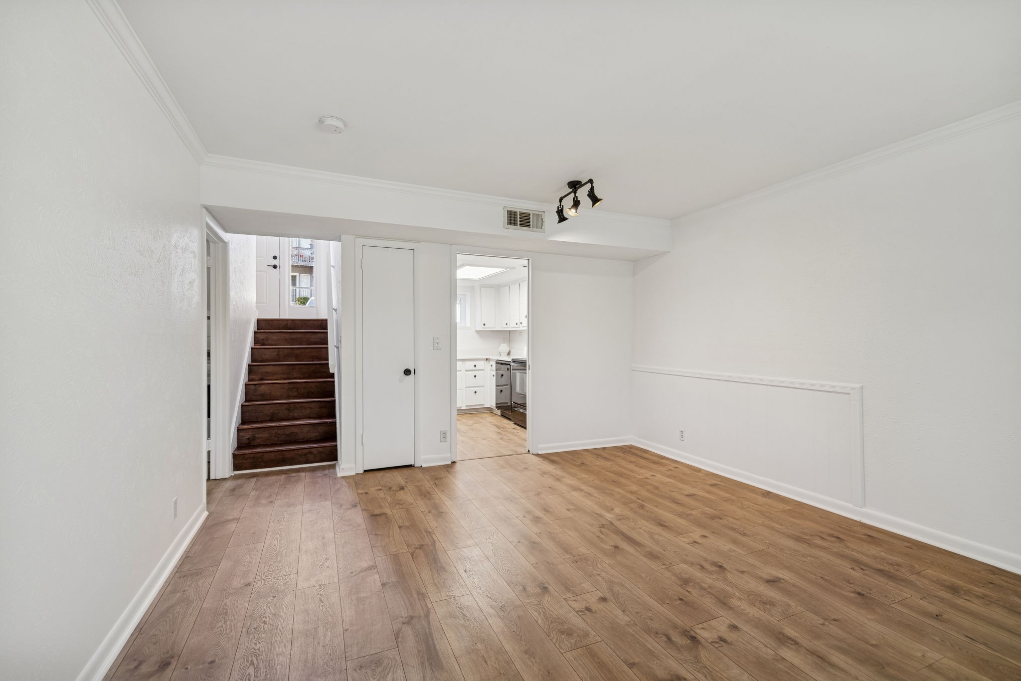21 Vaughns Gap Road, Unit 14 Nashville, TN 37205 - Photo 3 of 26 a view of an empty room with wooden floor and stairs