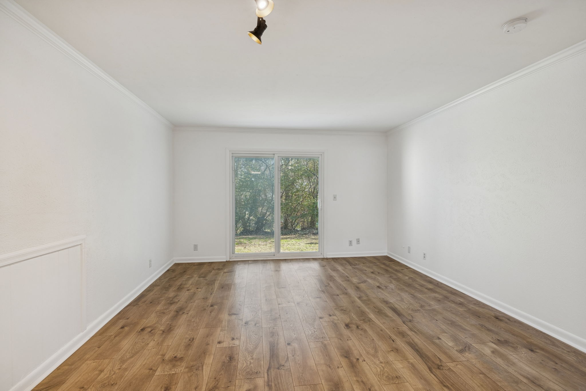 21 Vaughns Gap Road, Unit 14 Nashville, TN 37205 - Photo 5 of 26 an empty room with wooden floor and windows