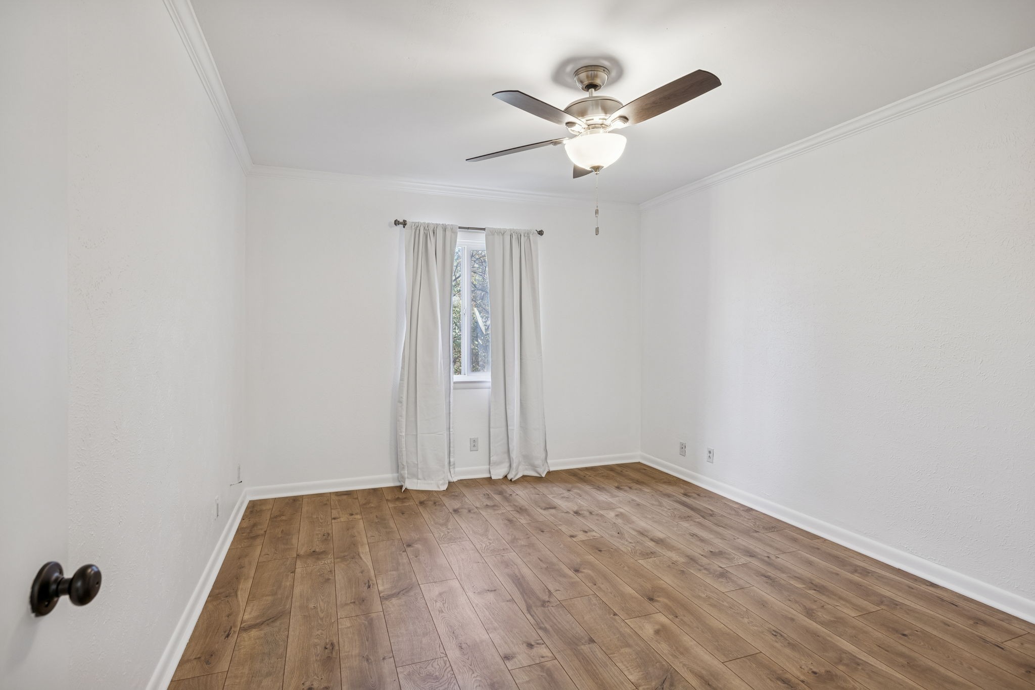 21 Vaughns Gap Road, Unit 14 Nashville, TN 37205 - Photo 9 of 26 an empty room with a chandelier fan and wooden floor