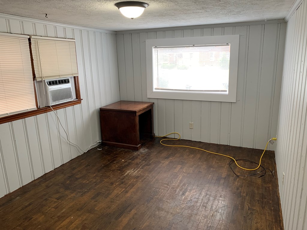 1903 1/2 35th Street Columbus, GA 31904 - Photo 4 of 6 a view of an empty room with wooden floor and a window