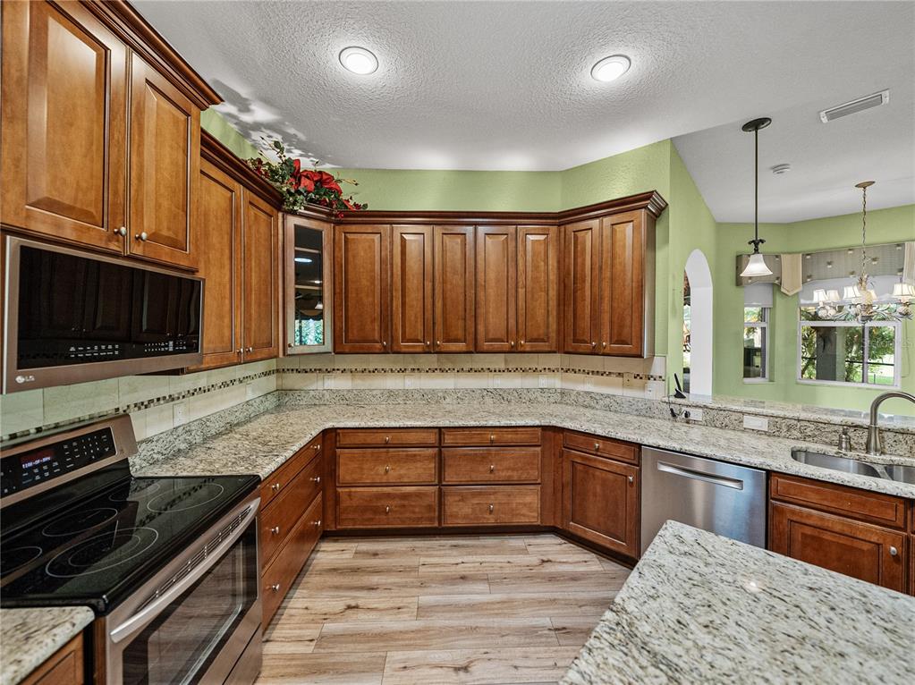 4004 Sable Loop Drive Lake Wales, FL 33859 - Photo 20 of 94 a large kitchen with granite countertop a stove and a sink