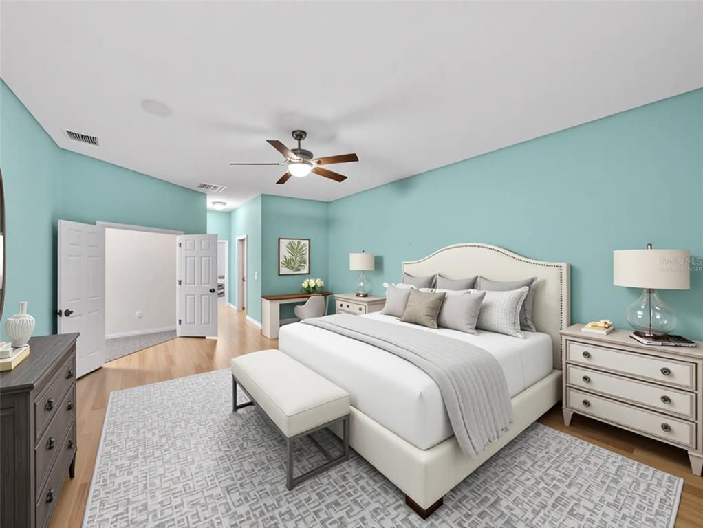 4004 Sable Loop Drive Lake Wales, FL 33859 - Photo 22 of 94 a bedroom with a bed and a chandelier