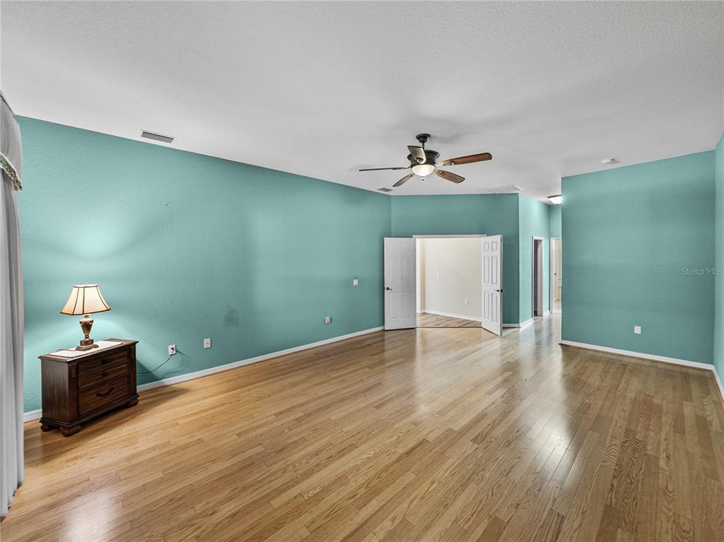 4004 Sable Loop Drive Lake Wales, FL 33859 - Photo 26 of 94 a view of a room with wooden floor and ceiling fan