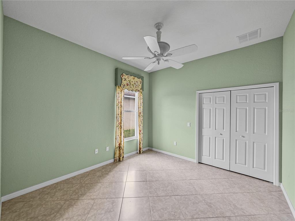 4004 Sable Loop Drive Lake Wales, FL 33859 - Photo 35 of 94 an empty room with a ceiling fan and a window