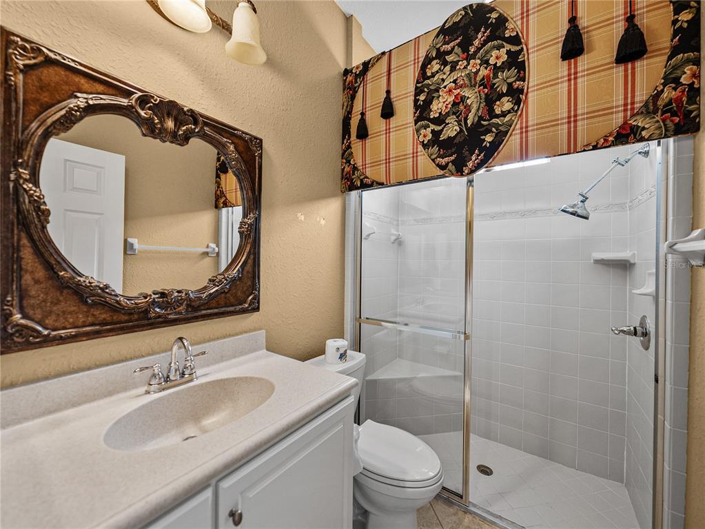 4004 Sable Loop Drive Lake Wales, FL 33859 - Photo 37 of 94 a bathroom with a sink and mirror with toilet