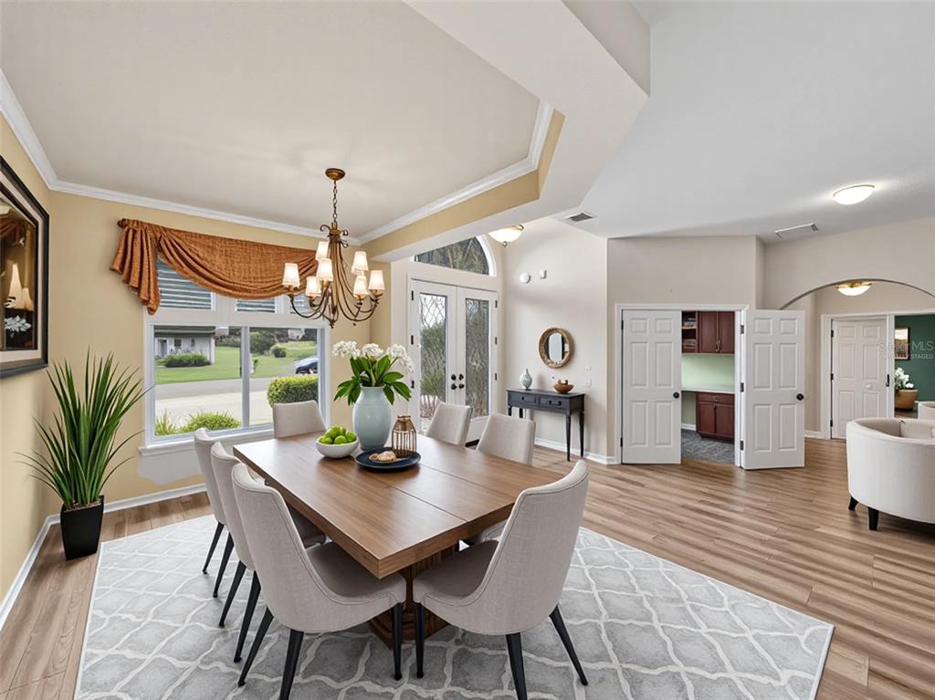 4004 Sable Loop Drive Lake Wales, FL 33859 - Photo 4 of 94 a dining room with furniture wooden floor and a chandelier