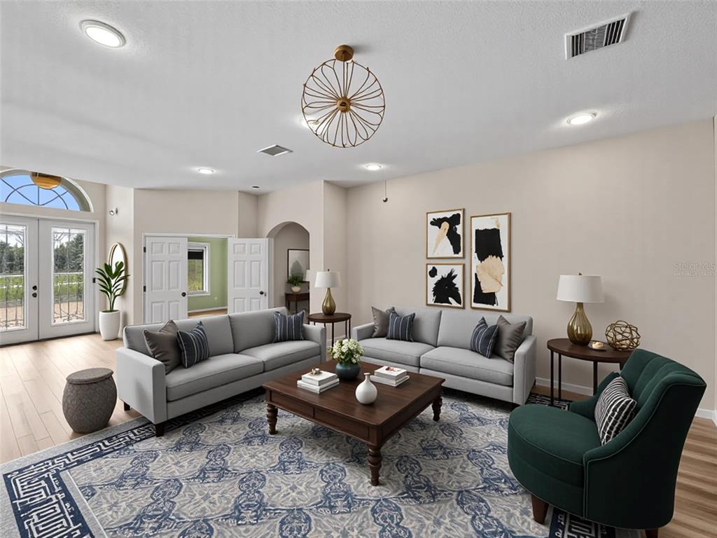 4004 Sable Loop Drive Lake Wales, FL 33859 - Photo 6 of 94 a living room with furniture a rug and a chandelier